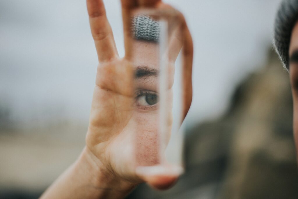 Reflection of human face on small mirror.