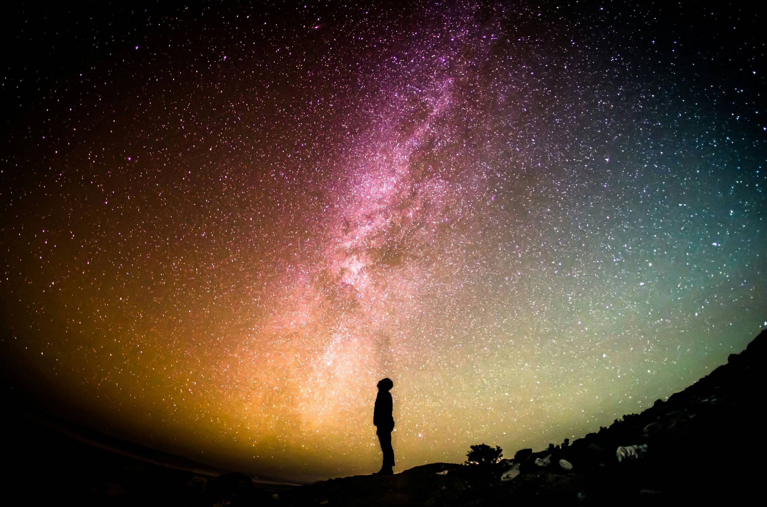 Man looking up towards starry night.