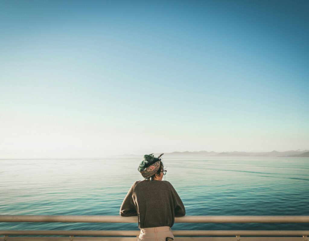Woman looking an Ventura beach from pier.