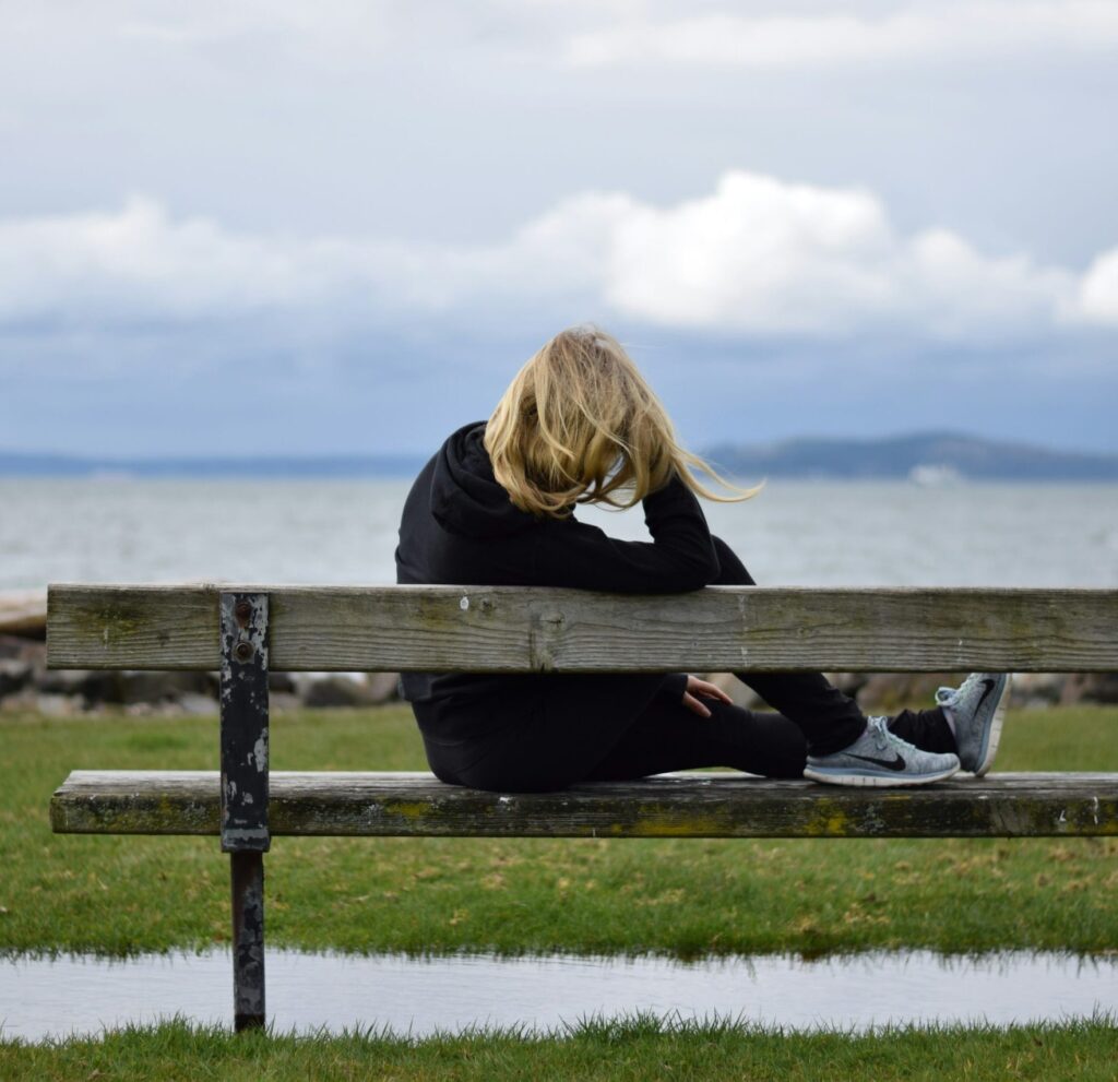 Contemplative woman overlooking ocean.